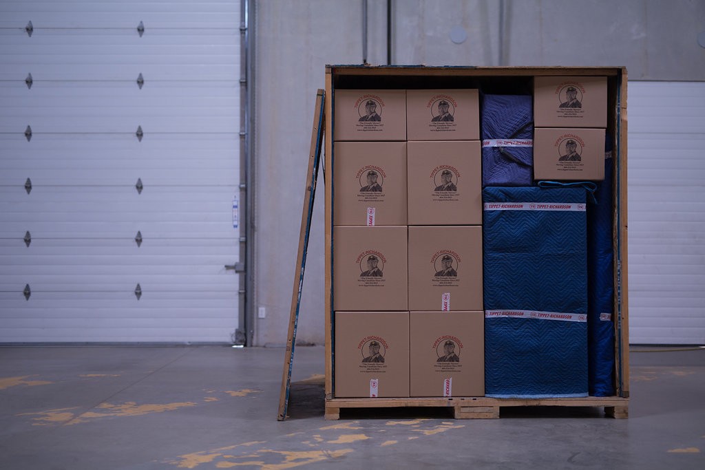 Open moving crate parked in a Tippet Richardson professional storage facility