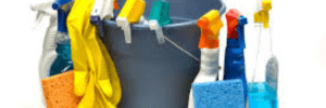 Blue bucket holding yellow gloves, orange and blue sponges, and other cleaning supplies