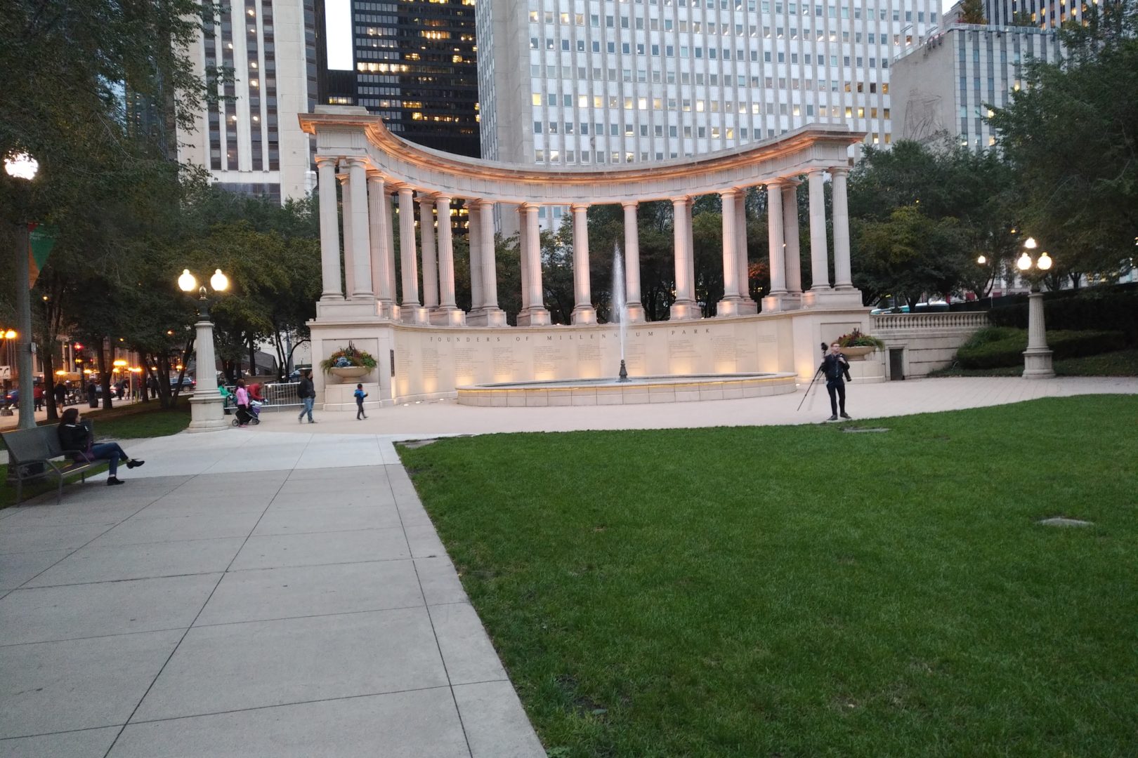 Man standing with a camera in front of the Millennium Monument